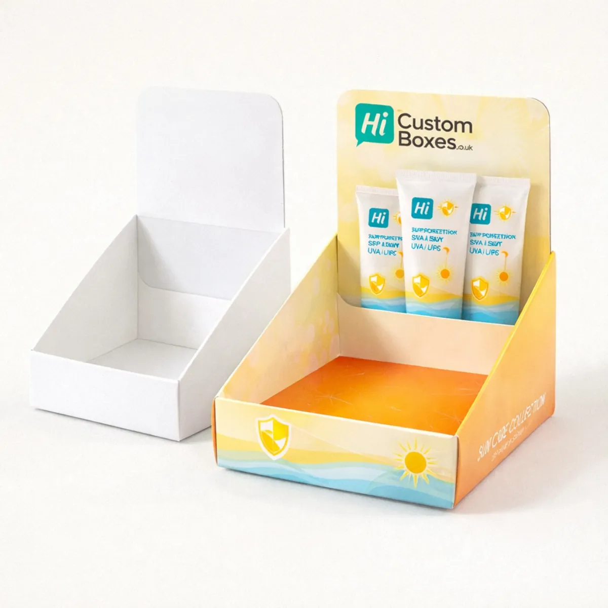 Two cardboard counter display units- one plain white and one containing three branded cream tubes- class=